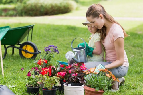 Worker wearing PPE while operating garden machinery